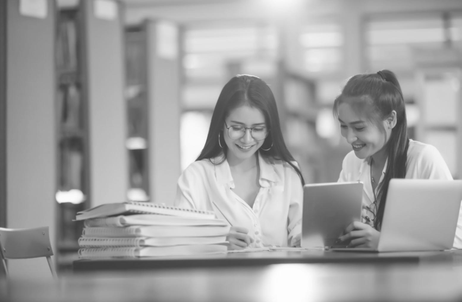 Students collaborating on budget analysis project in modern classroom setting