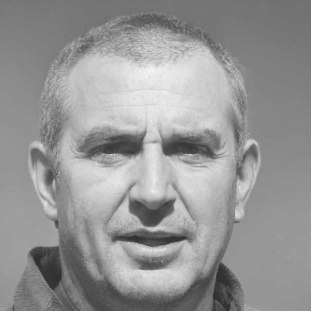 Team member Dmitrij Voronkov collaborating with colleagues in modern office environment